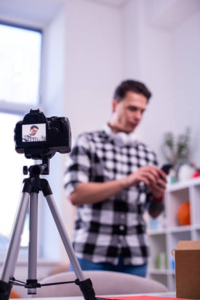 istock Dark-haired young man shooting new video for his channel 1146734988