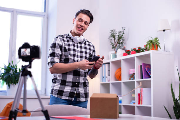 istock Active good-looking guy wearing checkered shirt and white headphones 1146734990