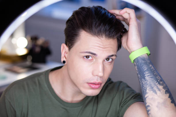 istock Narcissistic dark-haired young man staying in light circle 1146735644
