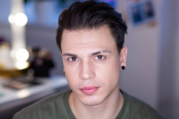 istock Handsome shaved dark-haired guy sitting in bright studio lights 1146735690