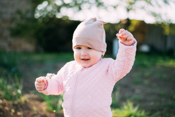 istock a little girl with a dandelion in her hands 1146738332