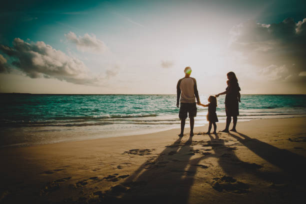 istock happy family with kids walk on sunset beach 1146739430