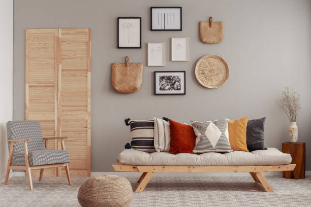 istock Red, yellow and patterned pillows on elegant scandinavian living room sofa 1146741215
