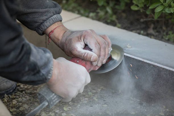 worker grinds granite stone with an diamond electric saw blade worker grinds granite stone with an diamond electric saw blade grinding metal power work tool stock pictures, royalty-free photos & images