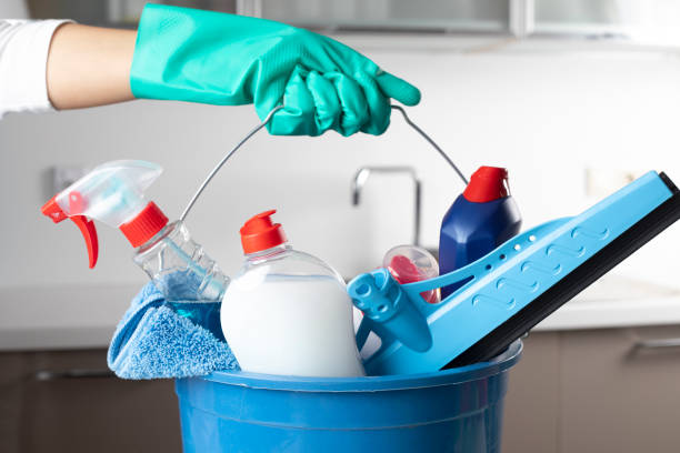 Cleaning Bucket Woman holding cleaning products with glove. cleaning product stock pictures, royalty-free photos & images