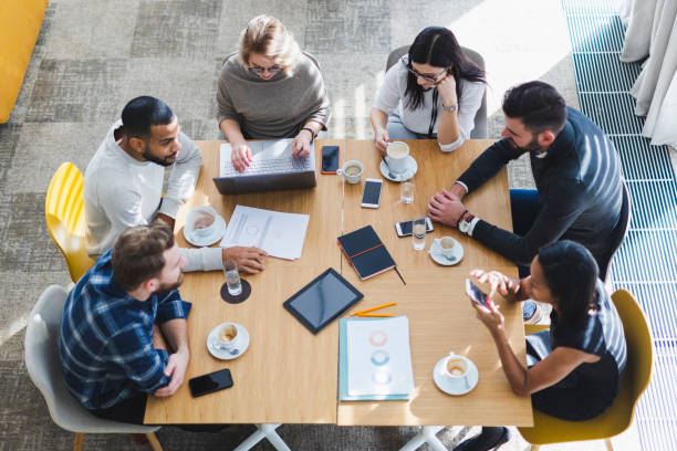 istock Overhead view of people working in a cafe 1146743544