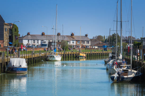 Sailboats on the River Rother in Rye, with people River Rother in Rye with sailboats​ and people enjoying a sunny spring day. rye stock pictures, royalty-free photos & images