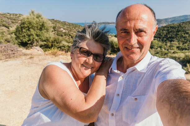 istock Senior couple taking selfies at the seaside 1146746271