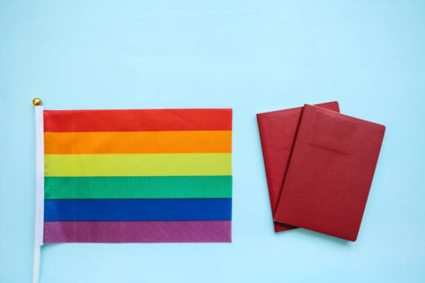 istock The multi-colored flag is a rainbow-colored or LGBT flag next to a passport. LGBT migration 1146746696