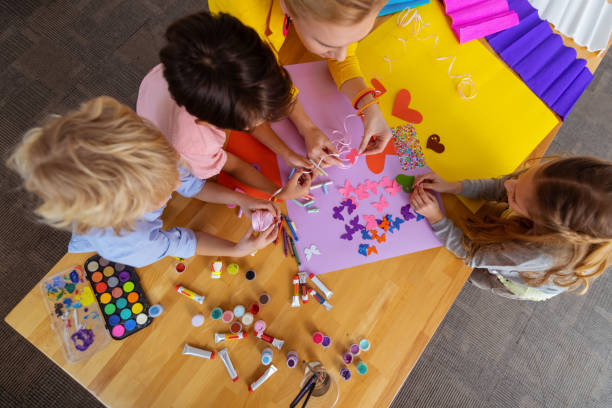 istock Pupils and teacher using colorful paper and gouache at lesson 1146747293