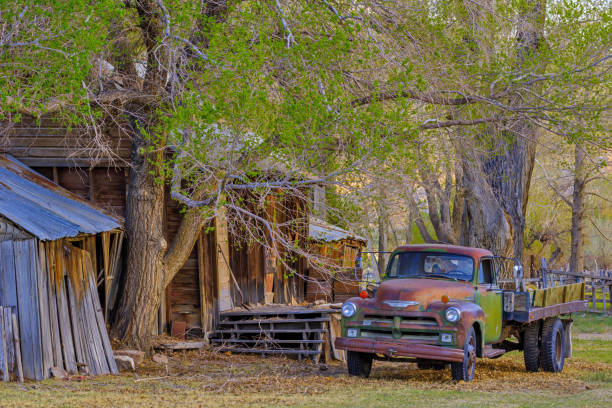Northern California coast on April 10, 2015: Relic pick up truck by old barn in Owens valley and the Sierra Nevada countryside in the state of California
