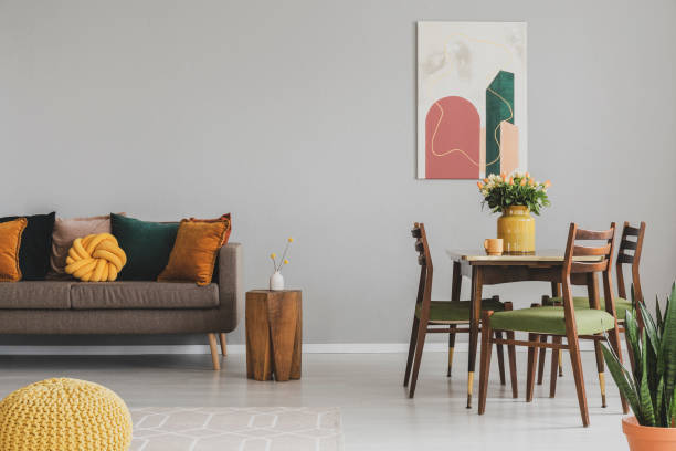 istock Vintage living and dining room interior with retro table with chairs and comfortable sofa with pillows 1146750961