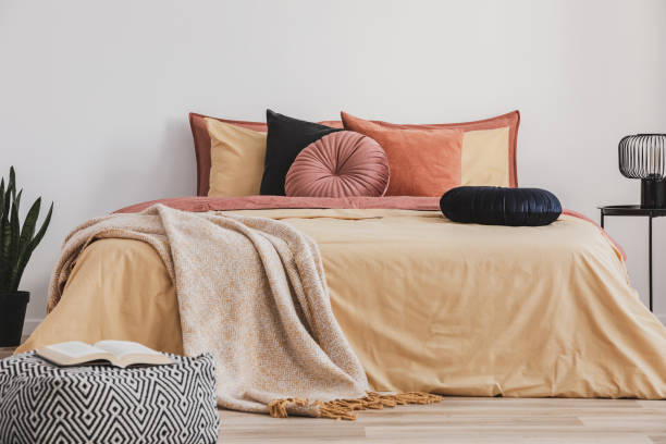 istock Open book on patterned pouf in colorful bedroom interior 1146752247