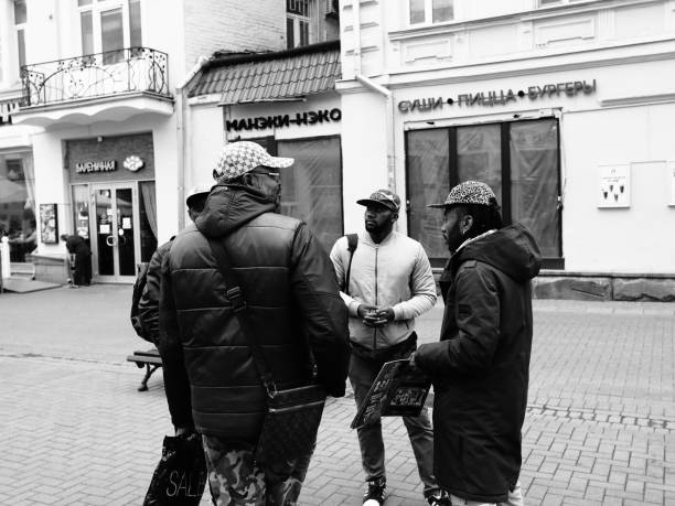 Moscow, Russia - May 03, 2019: a group of african men talking while standing on Arbat street