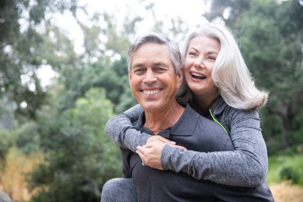 istock Senior Couple Piggyback Ride in Park 1146753674