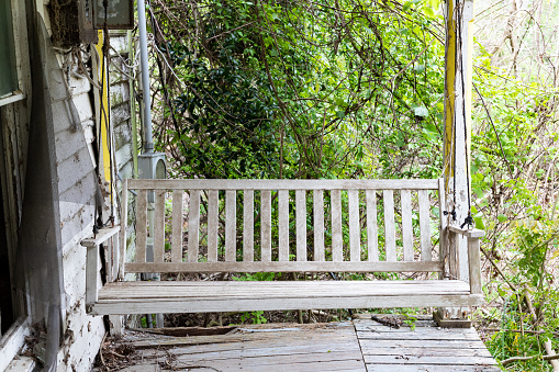 Swinging bench on the porch of an abandoned house in Pamlico County, NC.