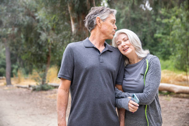 istock Senior Couple Walking and Talking in the woods 1146753932