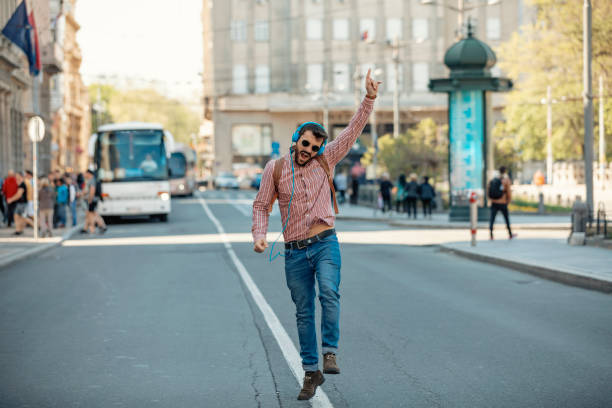 istock Young Man Walking on the City Road in a Dancing Mood 1146754012
