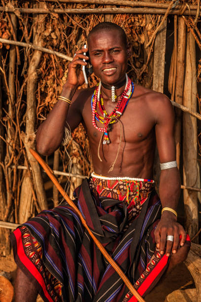 istock Young man from Erbore tribe using a smart phone, Ethiopia, Africa 1146754210