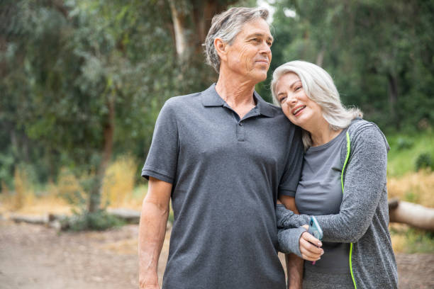 istock Senior Couple Walking and Talking in the woods 1146754357