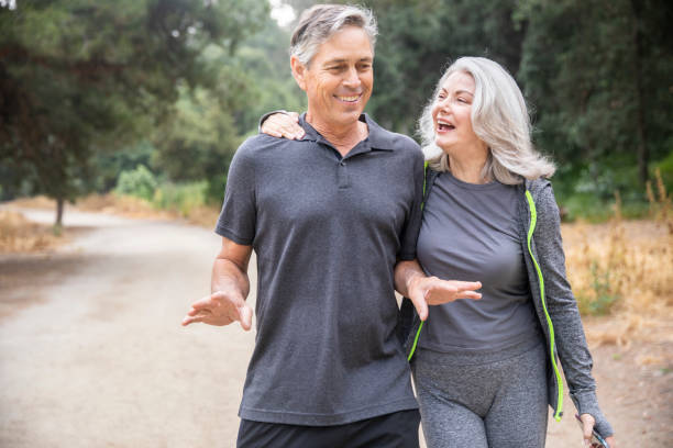 istock Senior Couple Walking and Talking in the woods 1146754970