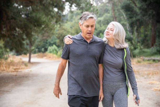 istock Senior Couple Walking and Talking in the woods 1146755024