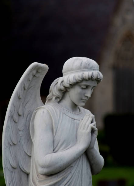 istock Praying angel statue in cemetery 1146756518