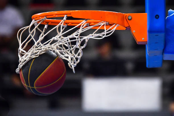 istock Ball falling through a Basketball Hoop 1146761736