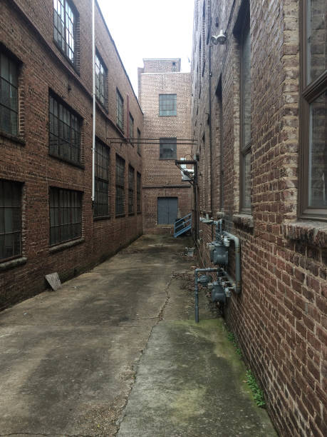 istock View down a long alley between brick industrial buildings 1146761781