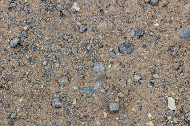 istock Sandy texture, coast, river bank. Large sand with small stones, bright sunlight. Rest, summer, beach. 1146767482