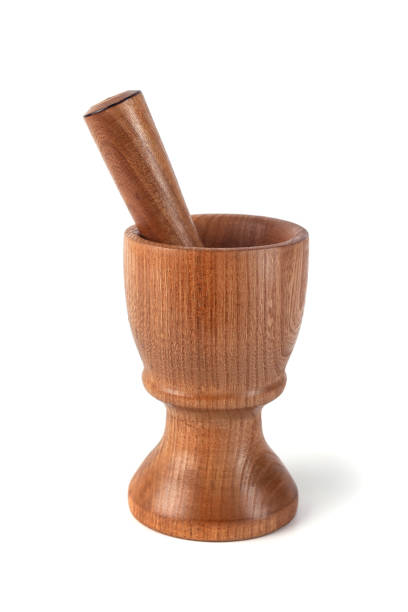 istock Wooden mortar (pounder) and pestle isolated on white 1146769199