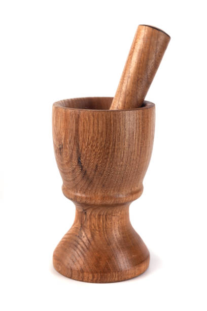 istock Wooden mortar (pounder) and pestle isolated on white 1146769211