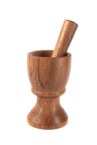 istock Wooden mortar (pounder) and pestle isolated on white 1146769214