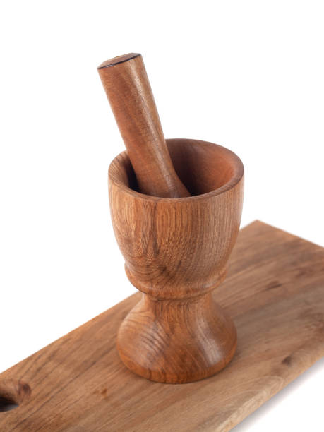 istock Wooden mortar (pounder) and pestle isolated on white 1146769218