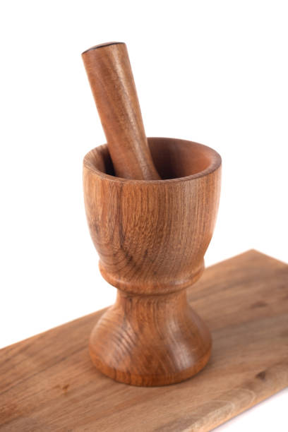 istock Wooden mortar (pounder) and pestle isolated on white 1146769222