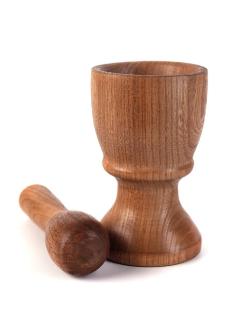 istock Wooden mortar (pounder) and pestle isolated on white 1146769243
