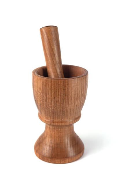 istock Wooden mortar (pounder) and pestle isolated on white 1146769260