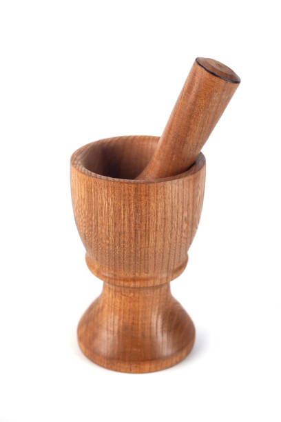 istock Wooden mortar (pounder) and pestle isolated on white 1146770252