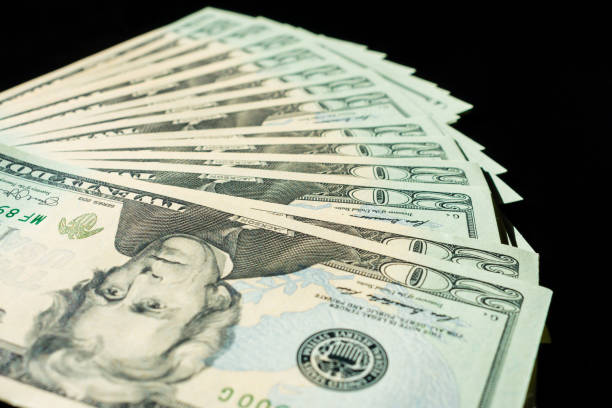 closeup of twenty dollar bills fanned out on black background - twenty dollar bill us currency currency fanned out imagens e fotografias de stock