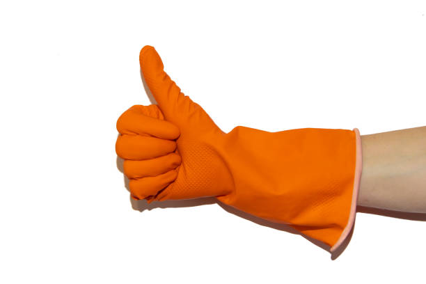 istock Orange rubber glove on hand isolated on white background. Clean hands when cleaning. Isolated object. Body parts. Cleaning. 1146773147