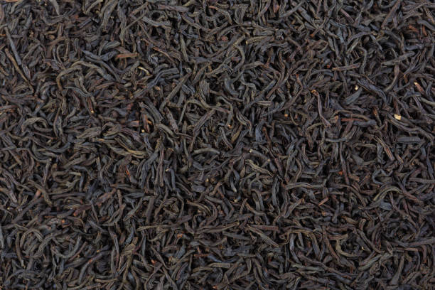 いくつかの乾燥し、発酵アールグレイ茶葉は、背景パターンを形成します。 - tea tea leaves jasmine tea leaf ストックフォトと画�像