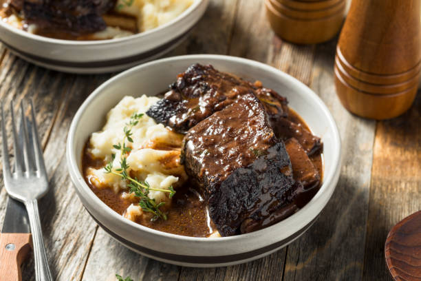 Homemade Braised Beef Short Ribs Homemade Braised Beef Short Ribs with Gravy and Potatoes braised stock pictures, royalty-free photos & images