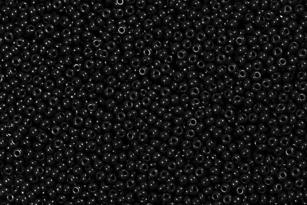 istock Black high quality glass beads texture on macro. 1146774509
