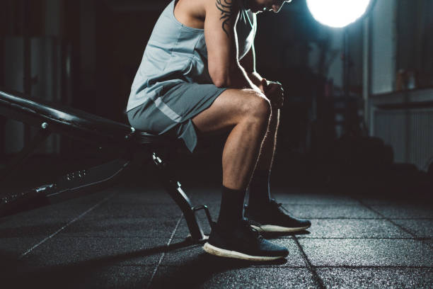 istock A young man with tattoos sitting on a bench in gym 1146774702