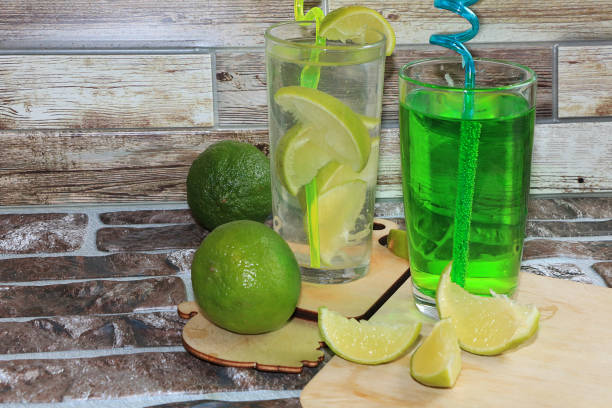 istock Lime in glass goblets and fruit with mint on a wooden table. 1146775453