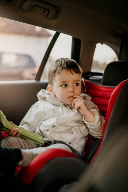 istock Little boy sitting car in child seat 1146775466
