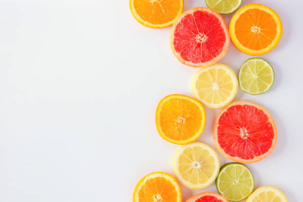 istock Colorful fruit side border of citrus slices, top view over a white background 1146777882