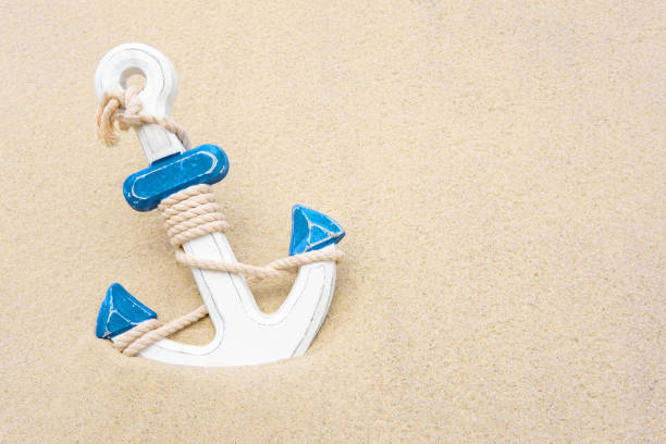 Nautical background with anchor. Anchor in the sand. Frame for a banner text from sand with