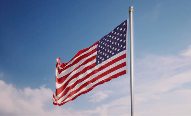 istock American Flag Waving With Wind Over Blue Sky 1146779596