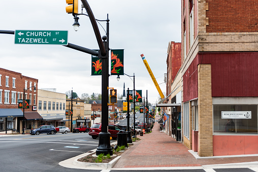 Wytheville, USA - April 19, 2018: Small town village street signs for Church and Tazewell intersection in southern south Virginia, historic brick buildings and office supply store